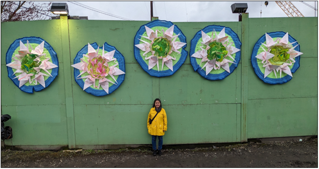 Lin-Lin Mao Mollitor stands in front of her work entitled Be Like Lotus