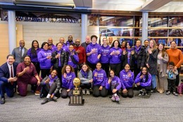 Mayor Harrell and members of the Garfield Basketball teams pose at City Hall with the championship trophy.