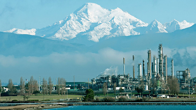 An oil refinery with Mt. Baker in the distance