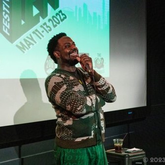 Comedian holding microphone and laughing