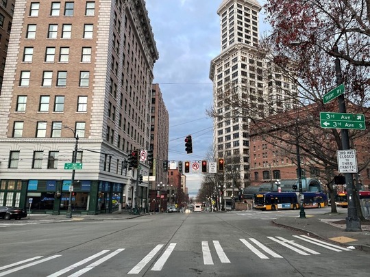 Buses travel on 3rd Ave and Yesler Way in the south end of downtown Seattle
