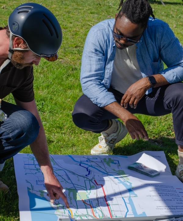 Two people looking at a project map and talking together