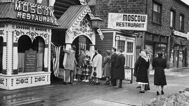 Black and white image of people lined up in front of Moscow Restaurant