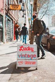 sign in front of U District shop