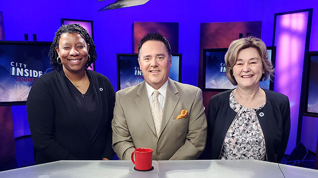 From left to right, Councilmember Hollingsworth, Brian Callanan, Councilmember Moore stand smiling in studio