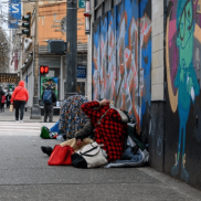 Photo of people sitting on the street corner in Seattle.