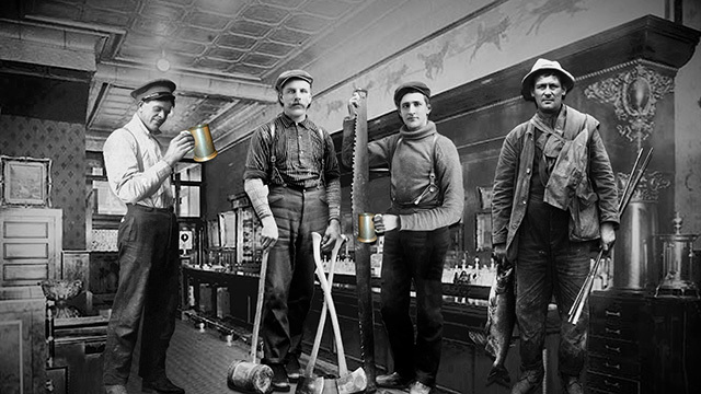 Black and white image of pub with four men standing, holding steins and saws