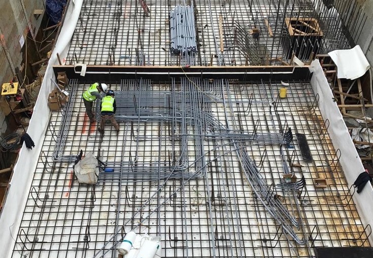 Crews at the East Ballard site install a complex array of electrical conduits inside the base slab of the mechanical and electrical vault.