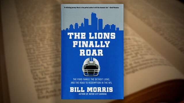 Blue book cover with Detroit cityscape, title reads "The Lions Finally Roar" overlayed on blurred book page