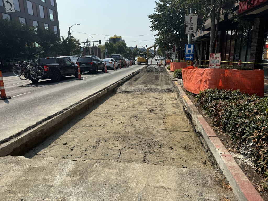 A section of concrete that has been removed from a lane of 15th Ave NW.