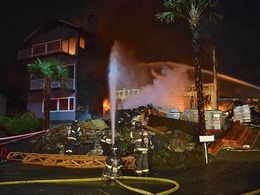 Firefighters put water on a house on fire in the 4000 block of 43rd Avenue South, near Genesee Park.