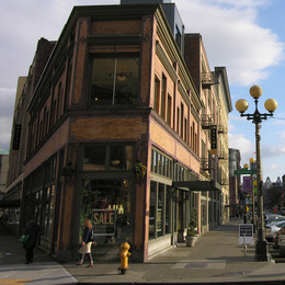 Sidewalk with vintage street light and historic brick building