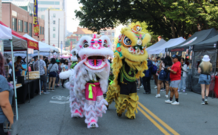A traditional lion dance performance at a street fair
