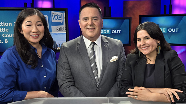 From left to right, Tanya Woo, Brian Callanan, Alexis Mercedes Rinck in television studio with blue background