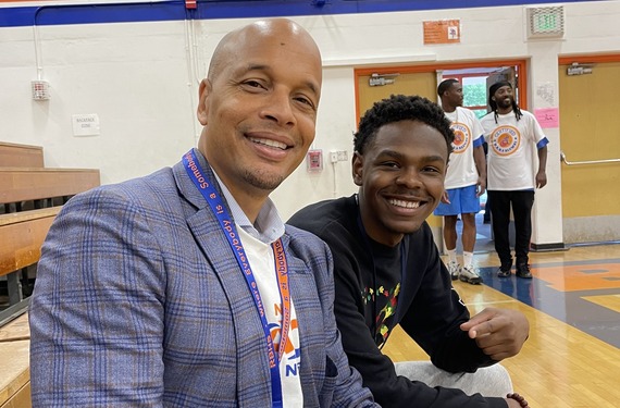 A smiling Dr. Dwane Chappelle, DEEL Director, visits with a Black scholar at Rainier Beach High School for the first day of classes