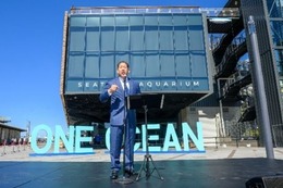 Mayor Harrell stands in front of the new Ocean Pavilion on the waterfront