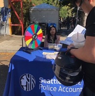 OPA staff sitting at a table at the C-ID Night Market on Saturday, September 21st, 2024
