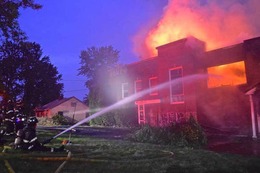 Firefighters battle a two-alarm fire in a vacant building in the 9200 block of Renton Avenue South in the Rainier Beach neighborhood.
