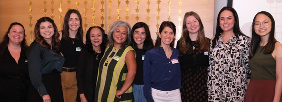 A group photo of Seattle Women's Commissioners pose with local author, Angela Garbes. 