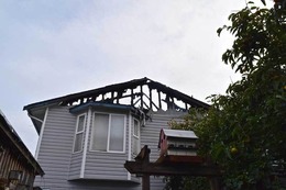 Fire burns through the roof of a home in the 8400 block of 13th Avenue Southwest