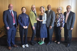 Group of people posed for photo and holding the CDBG 50th Award