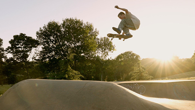 A skateboarder silhouetted by the sun