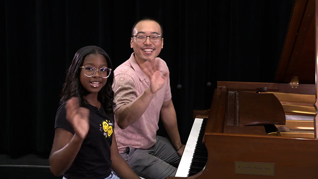  Mr. Gene plays piano with a student at the Seattle Opera