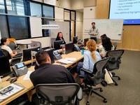One of the breakout groups discusses how to support the community and organizations in the supply chain after a natural disaster