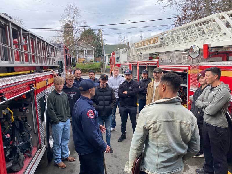 Firefighter talks with people interested in the career at Fire Station 28 in Columbia City.