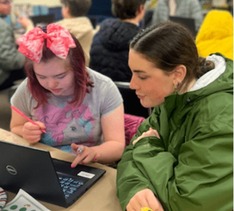 woman helping developmentally disabled teenager