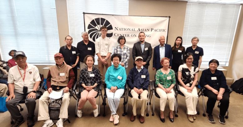 group of older Asian people posing for a group shot