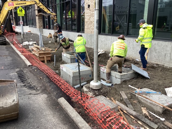 Crews installing electrical vaults before pouring concrete on new sidewalk on east side of Rainier Ave S and S Grand St.