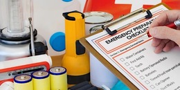 image of emergency supplies such as flashlight, water, canned food, checklist, batteries