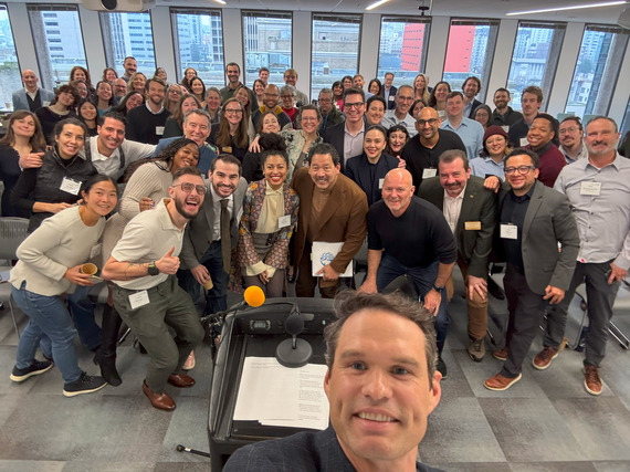 Markham takes an "ussie" of group attending SCIH opening