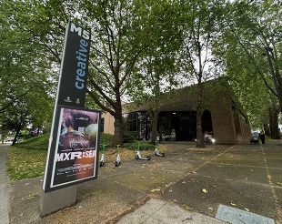 View of M5 Creative sign with building in the background