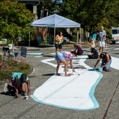 group of people painting a street
