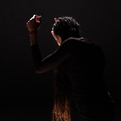 Black woman dancing in a dark background