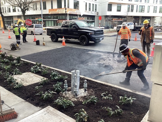 Crews paving asphalt on Rainier Ave S at S Grand St.