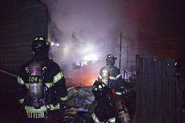 Firefighters work to extinguish a fire in a home