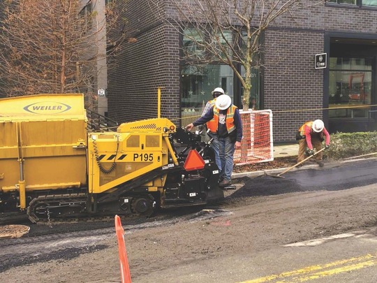 Crews placing temporary asphalt along Eastlake Ave E.