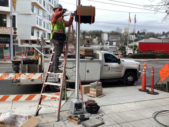 Crews installing new pedestrian signal at the northeast corner of Rainier Ave S and S Grand St.