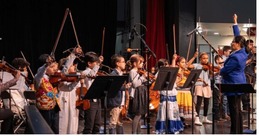 children playing instruments in an orchestra