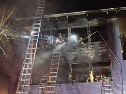Firefighters inside an apartment building fire.