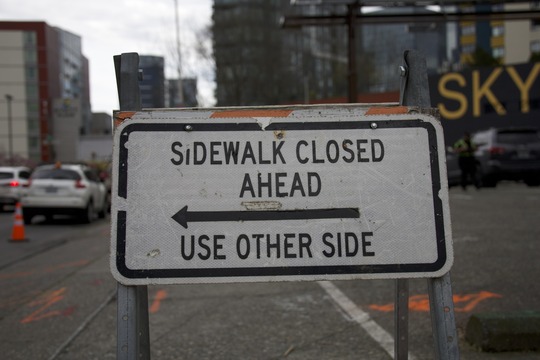 Sign Reading, "Sidewalk Closed Ahead, Use Other Side"