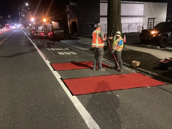 Crews installing Bus Only lane striping on Rainier Ave S near S Walden St.