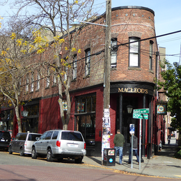 A brick building with round front on a street corner