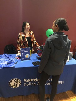 OPA Complaint Navigator and Outreach Specialist, Serenna Duncan, chatting with an event attendee