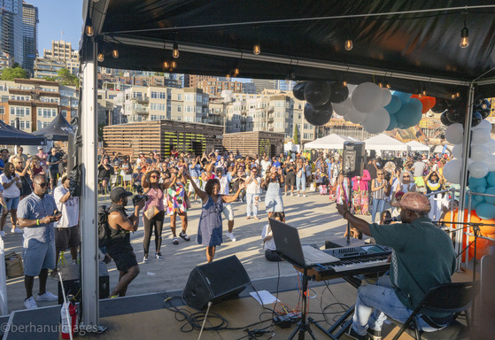 People dancing during an outdoor performance on the Seattle Waterfront