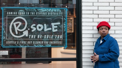 ReSole owner standing in front of storefront and new sign