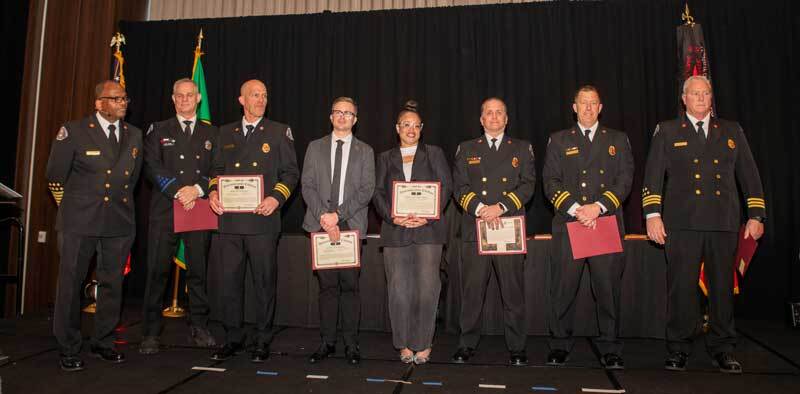 Firefighters and civilian staff accepting an award